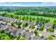 Aerial view of houses, a golf course, and surrounding landscape at 15482 Bridgewater Club Blvd, Carmel, IN 46033