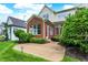 Spacious patio with landscaping and a brick house at 15482 Bridgewater Club Blvd, Carmel, IN 46033