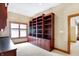 Large home office featuring extensive built-in shelving at 15482 Bridgewater Club Blvd, Carmel, IN 46033