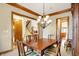 Formal dining room with chandelier and views to kitchen and stairs at 15482 Bridgewater Club Blvd, Carmel, IN 46033