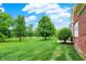 View of the backyard with green grass and trees at 15482 Bridgewater Club Blvd, Carmel, IN 46033