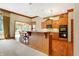 Eat-in kitchen with granite countertops and wooden cabinets at 15482 Bridgewater Club Blvd, Carmel, IN 46033