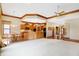 Open kitchen with island, hardwood floors, and ample cabinetry at 15482 Bridgewater Club Blvd, Carmel, IN 46033