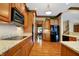 Open concept kitchen with granite counters and black appliances at 15482 Bridgewater Club Blvd, Carmel, IN 46033