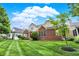 Red brick house with a well-manicured lawn at 15482 Bridgewater Club Blvd, Carmel, IN 46033