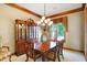 Formal dining room with wood table, chandelier, and built-in hutch at 15482 Bridgewater Club Blvd, Carmel, IN 46033