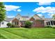 Two-story brick house with a lush green lawn at 15482 Bridgewater Club Blvd, Carmel, IN 46033