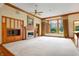 Open living room showcasing a fireplace and large windows overlooking the backyard at 15482 Bridgewater Club Blvd, Carmel, IN 46033