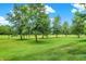 Landscaped green golf course with mature trees at 15482 Bridgewater Club Blvd, Carmel, IN 46033