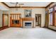 Bright living room featuring a fireplace, built-in shelving, and hardwood floors at 15482 Bridgewater Club Blvd, Carmel, IN 46033