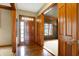 Hardwood floors and rich wood doors open to a home office at 15482 Bridgewater Club Blvd, Carmel, IN 46033