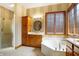 Elegant bathroom with double vanity, soaking tub, and separate shower at 15482 Bridgewater Club Blvd, Carmel, IN 46033
