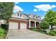 Brick house with a two-car garage and landscaped yard at 15482 Bridgewater Club Blvd, Carmel, IN 46033