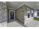 Stone front entrance with a blue door and a small covered porch at 11451 Neptune Dr, Fishers, IN 46040