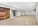 Spacious finished basement with wood feature wall and plush carpeting at 2929 Post Oak Ct, Westfield, IN 46074