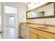 Bathroom with double vanity, light wood cabinets, and a mirror at 2929 Post Oak Ct, Westfield, IN 46074