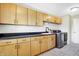 Functional laundry room, featuring wood cabinets and a utility sink at 2929 Post Oak Ct, Westfield, IN 46074