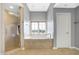 Spa-like bathroom featuring a soaking tub, walk-in shower, and window at 2929 Post Oak Ct, Westfield, IN 46074