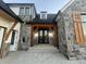 Elegant entryway with stone facade and a double door at 719 Wexford Hill Ct, Westfield, IN 46074