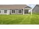 Home exterior showcasing a backyard with covered patio and lawn at 16910 Cattle Hollow Ln, Noblesville, IN 46060
