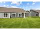 Home exterior showcasing a backyard with covered patio and lawn at 16910 Cattle Hollow Ln, Noblesville, IN 46060