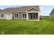Home exterior showcasing a backyard with covered patio and lawn at 16910 Cattle Hollow Ln, Noblesville, IN 46060