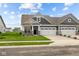 Craftsman style home with gray siding, stone accents, and a two-car garage at 16910 Cattle Hollow Ln, Noblesville, IN 46060