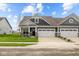 Craftsman style home with gray siding, stone accents, and a two-car garage at 16910 Cattle Hollow Ln, Noblesville, IN 46060
