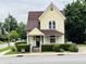Yellow house with brown roof and landscaping at 202 N State St, Greenfield, IN 46140