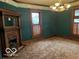 Dark green dining room with wood fireplace at 202 N State St, Greenfield, IN 46140
