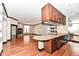 Kitchen with granite counter, wood cabinets, and hardwood floors at 350 N Meridian St # A301, Indianapolis, IN 46204