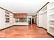 Open concept kitchen features hardwood floors, granite countertops, stainless steel appliances, and custom cabinetry at 350 N Meridian St # A301, Indianapolis, IN 46204