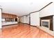 Open living area with hardwood floors, fireplace, and kitchen with island at 350 N Meridian St # A301, Indianapolis, IN 46204