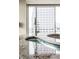 Sleek kitchen sink and faucet with city views in the background at 1 N Illinois St # 2101, Indianapolis, IN 46204