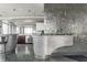 Modern kitchen design with curved metallic island and glass countertop at 1 N Illinois St # 2101, Indianapolis, IN 46204