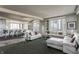 Spacious living room with white leather sectional sofa and city views at 1 N Illinois St # 2101, Indianapolis, IN 46204