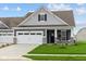 Gray Craftsman style home with a two-car garage and landscaped lawn at 16848 Cattle Hollow Ln, Noblesville, IN 46060