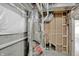 Unfinished basement with HVAC unit and framing at 220 Sanders St, Indianapolis, IN 46225