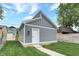 Detached gray garage with white door and walkway at 220 Sanders St, Indianapolis, IN 46225
