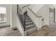 Modern staircase with gray carpet and metal railing at 220 Sanders St, Indianapolis, IN 46225