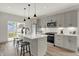 Modern kitchen with gray cabinets, white quartz countertops, and stainless steel appliances at 220 Sanders St, Indianapolis, IN 46225