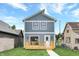 Rear view of a two-story gray house with a deck at 220 Sanders St, Indianapolis, IN 46225