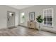 Light and airy entryway with wood-look floors and a gray door at 220 Sanders St, Indianapolis, IN 46225