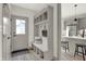 Functional entryway with built-in bench, storage cubbies, and view into the kitchen at 220 Sanders St, Indianapolis, IN 46225
