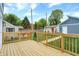 Wooden deck with railing, steps, and view of garage at 220 Sanders St, Indianapolis, IN 46225