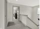 Upper hallway with carpet flooring and door to bedroom at 220 Sanders St, Indianapolis, IN 46225