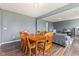 Bright dining area with wood floors and a wooden table, showcasing an open floor plan at 6089 Green Willow Rd, Whitestown, IN 46075