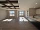 Spacious living area featuring hardwood floors, wood beam ceiling, and abundant natural light at 1157 Paul Revere Dr, Mooresville, IN 46158