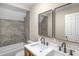 Modern bathroom with double vanity, large mirror, and grey tile at 618 N Gladstone Ave, Indianapolis, IN 46201