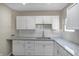 White shaker cabinets, granite countertops, and a tile backsplash at 618 N Gladstone Ave, Indianapolis, IN 46201